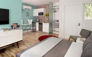 1816 Meridian Avenue, Unit 4 Miami Beach, FL 33139 - Photo 2 of 7 a bedroom with furniture and a flat screen tv