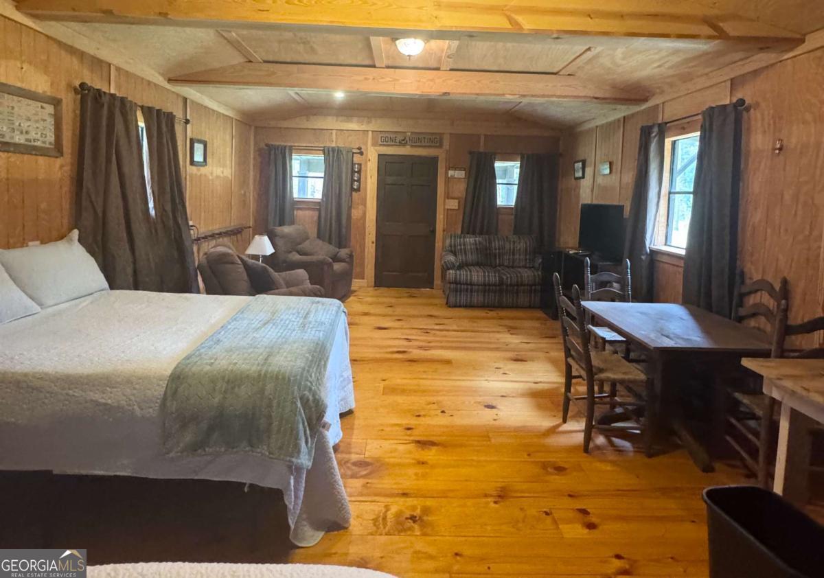 1603 Dl Durrence Road Reidsville, GA 30453 - Photo 17 of 28 a bedroom with a bed a table and chair