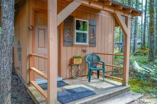 a view of balcony with two chairs and a rug