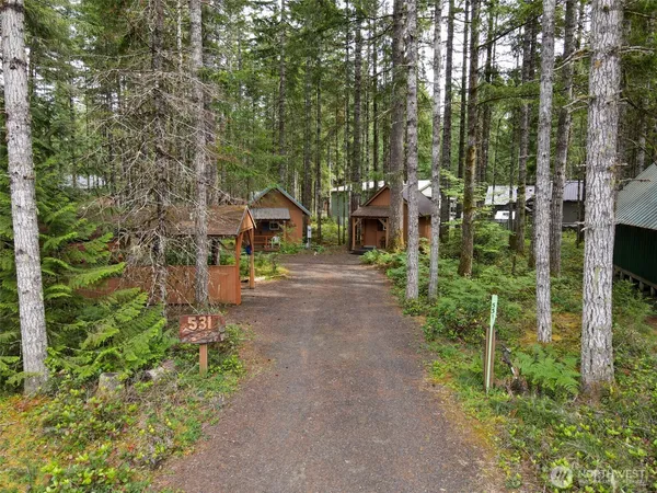 a pathway of a house with a yard