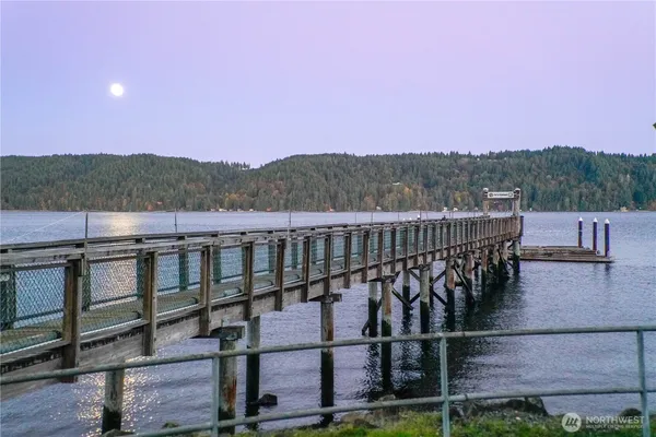 a view of a balcony with wooden floor and fence