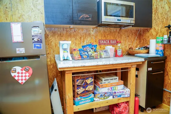 a utility room with stainless steel appliances and cabinets