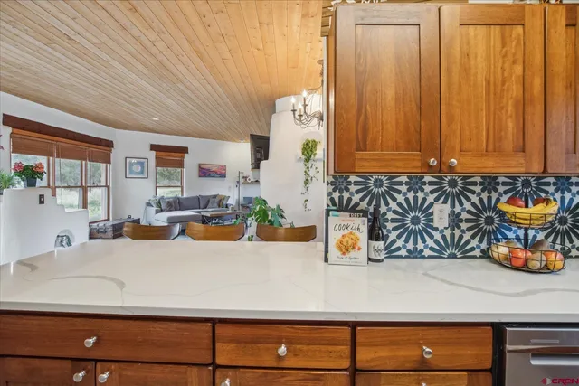 a view of a kitchen with furniture and wooden floor