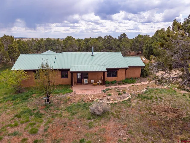 a view of a house with a yard and a wooden fence