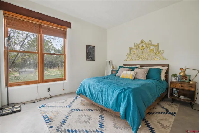 a bedroom with a bed and window