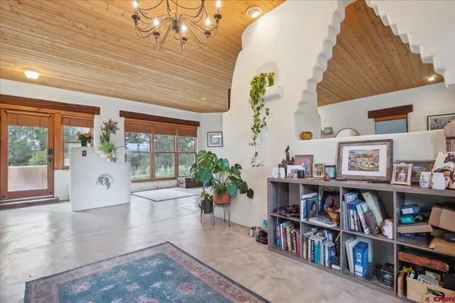 a living room with furniture and a book shelf