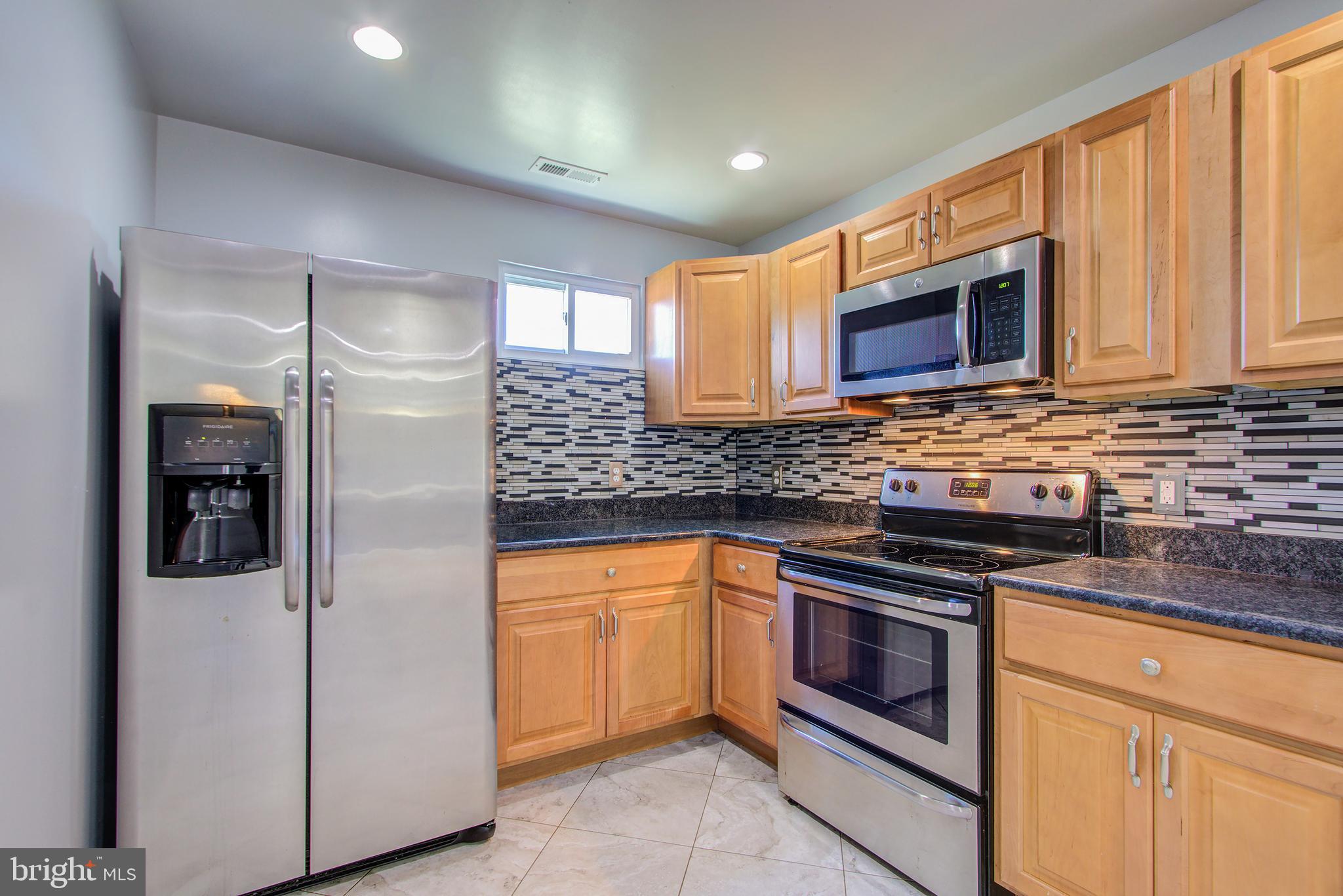 7511 Sandy Spring Road Laurel, MD 20707 - Photo 8 of 31 Kitchen has stainless appliances and ceramic floor