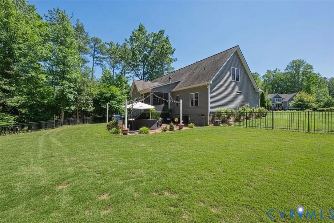6446 Chestnut Church Road Mechanicsville, VA 23116 - Photo 41 of 49 Expansive grassy lawn with a black metal fence enc