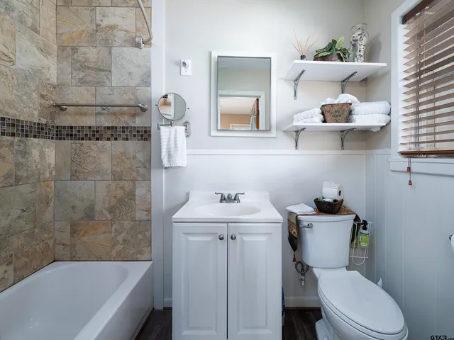 a bathroom with a sink a toilet and bathtub