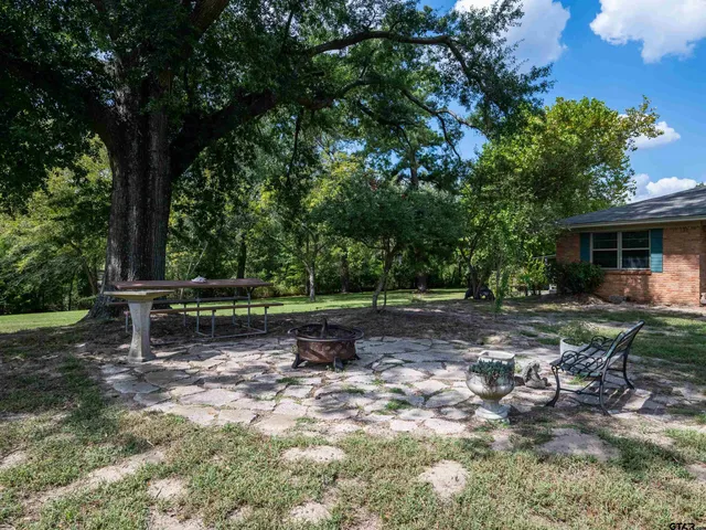 a view of a bench in a backyard