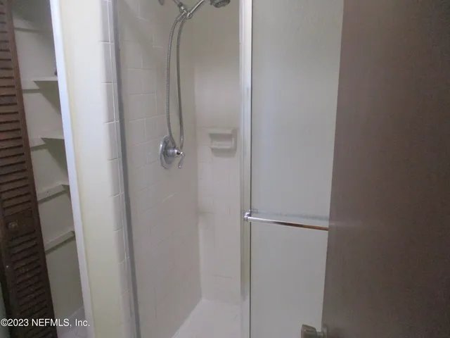 a bathroom with a glass door shower