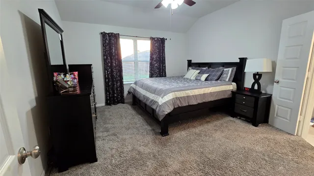 a bedroom with a bed and a television