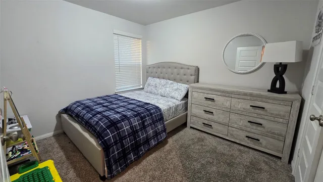 a bedroom with a bed and a dresser