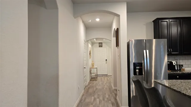 a view of a refrigerator in kitchen and wooden floor