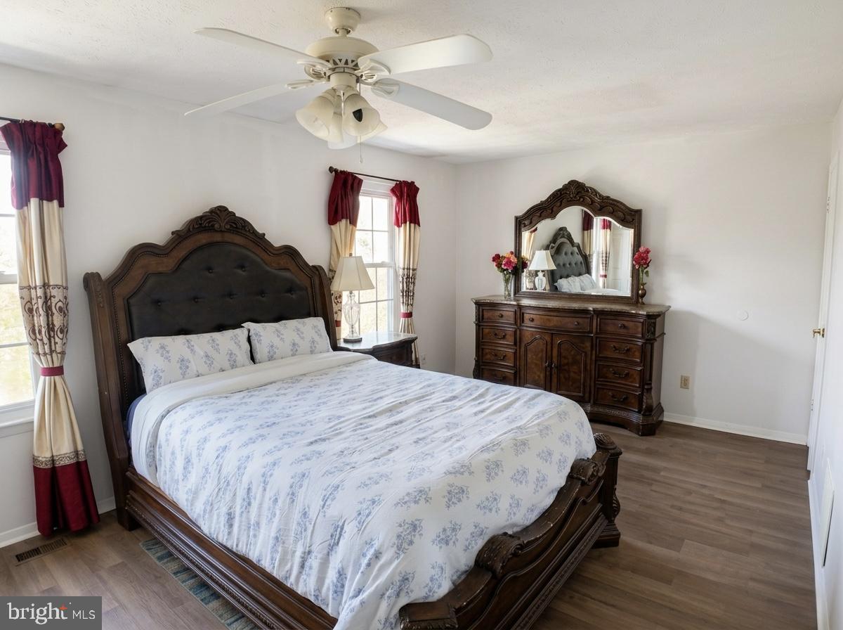 16 Powhurst Court Baltimore, MD 21236 - Photo 13 of 22 a bedroom with a bed and wooden floor