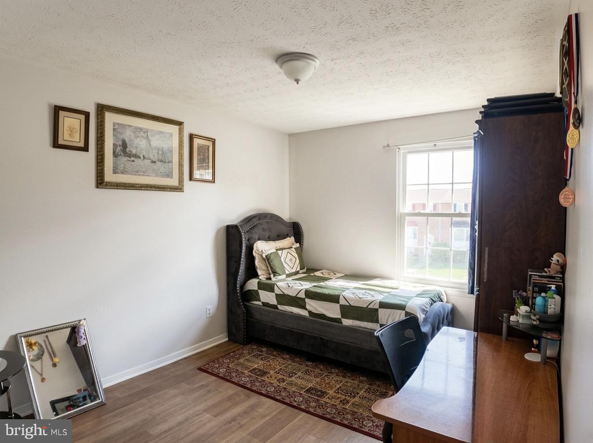 16 Powhurst Court Baltimore, MD 21236 - Photo 9 of 22 a bedroom with a bed and wooden floor