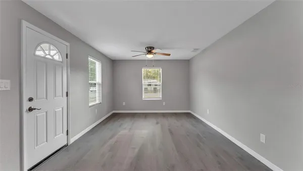 wooden floor in an empty room with a window