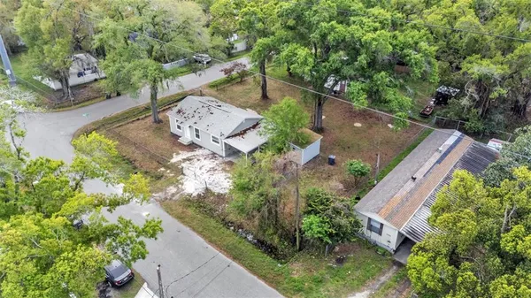 an aerial view of a house with a yard