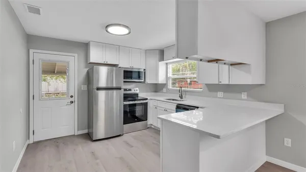 a kitchen with a refrigerator sink and stove