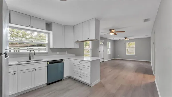 a kitchen with a sink cabinets and window