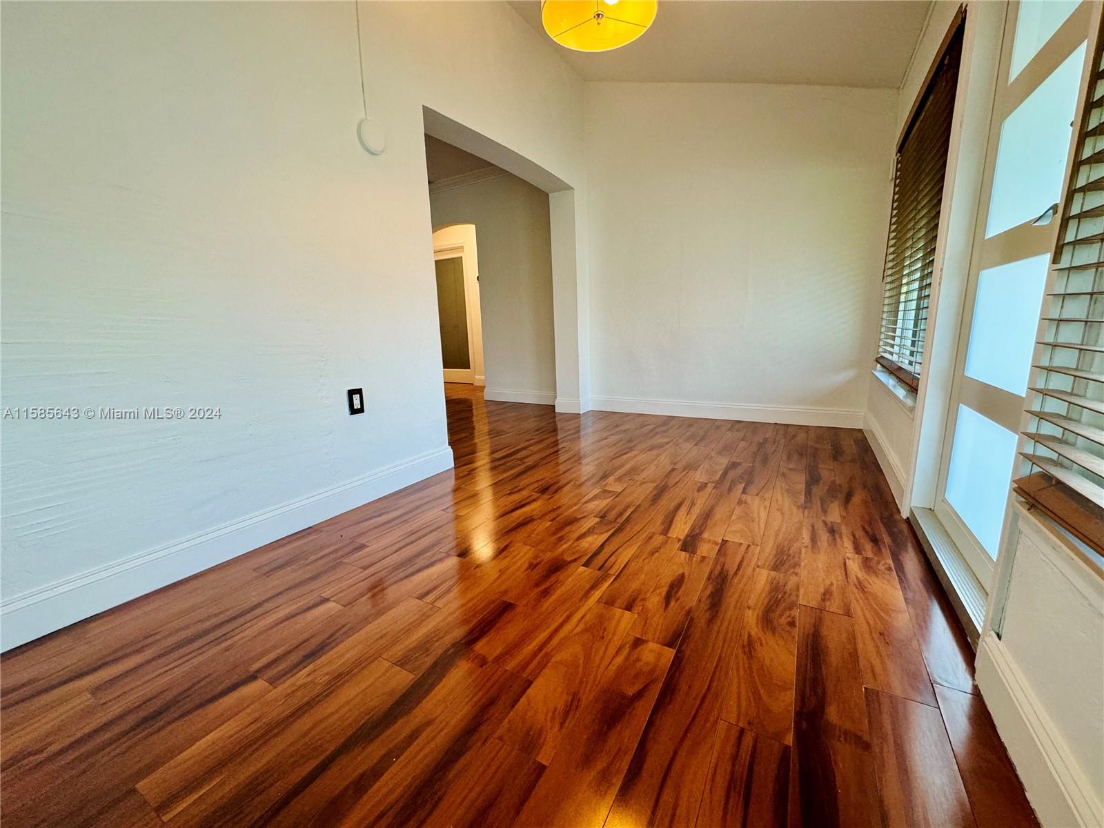 4235 Southwest 14th Street Miami, FL 33134 - Photo 11 of 32 a view of empty room with wooden floor and fan