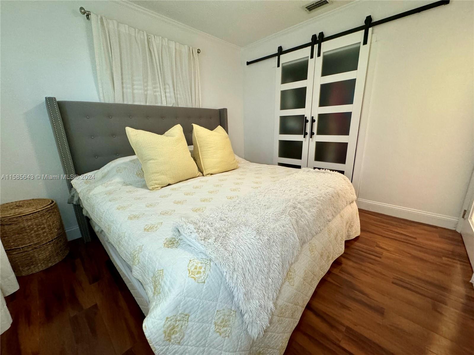 4235 Southwest 14th Street Miami, FL 33134 - Photo 15 of 32 a bed sitting in a bedroom next to a window with closet