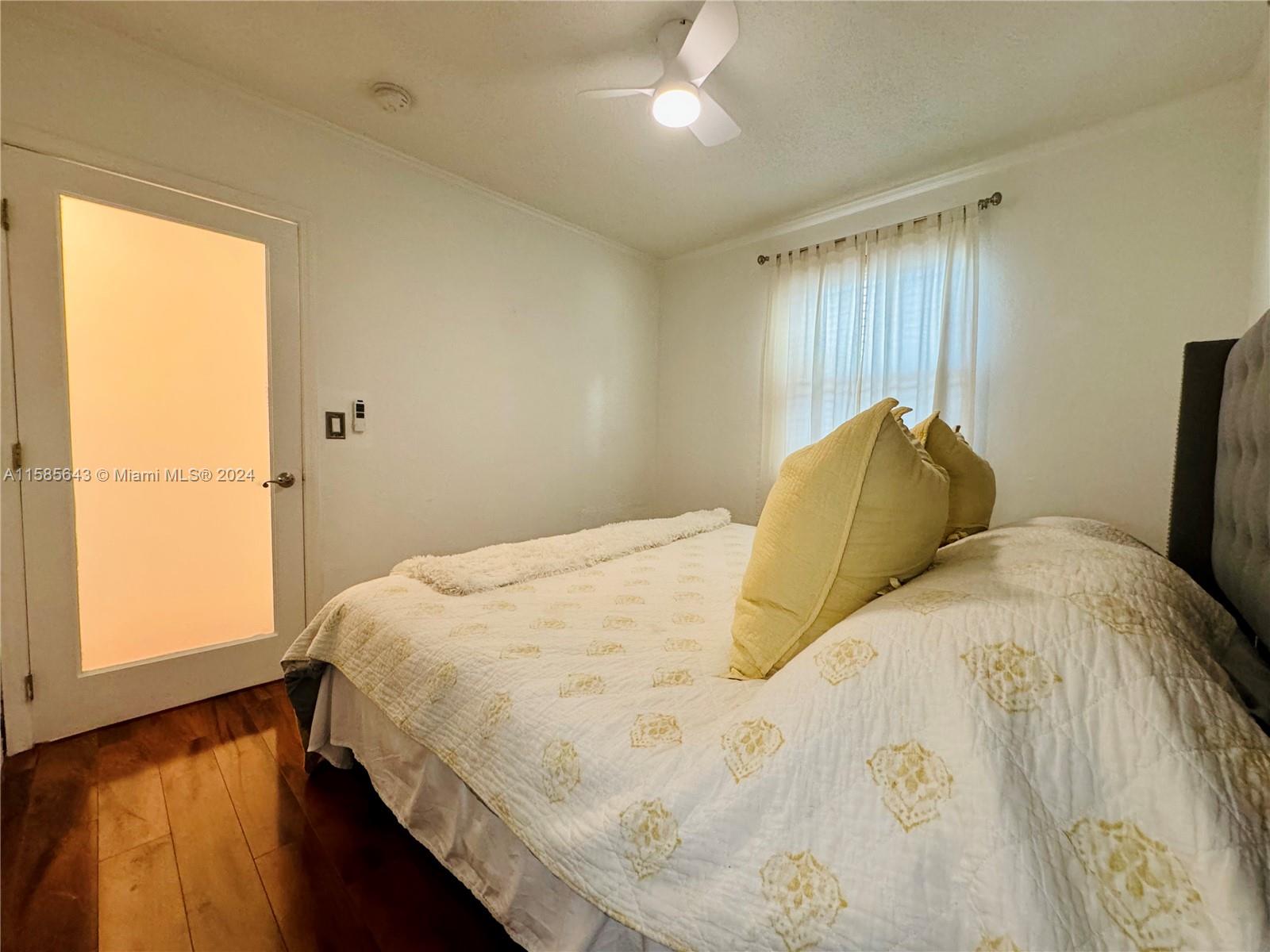 4235 Southwest 14th Street Miami, FL 33134 - Photo 16 of 32 a large bed sitting in a bedroom next to a window