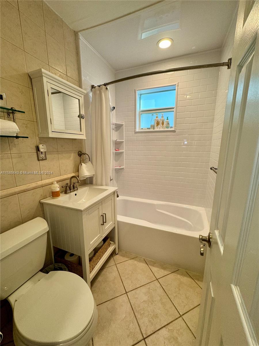 4235 Southwest 14th Street Miami, FL 33134 - Photo 23 of 32 a bathroom with a sink toilet and shower