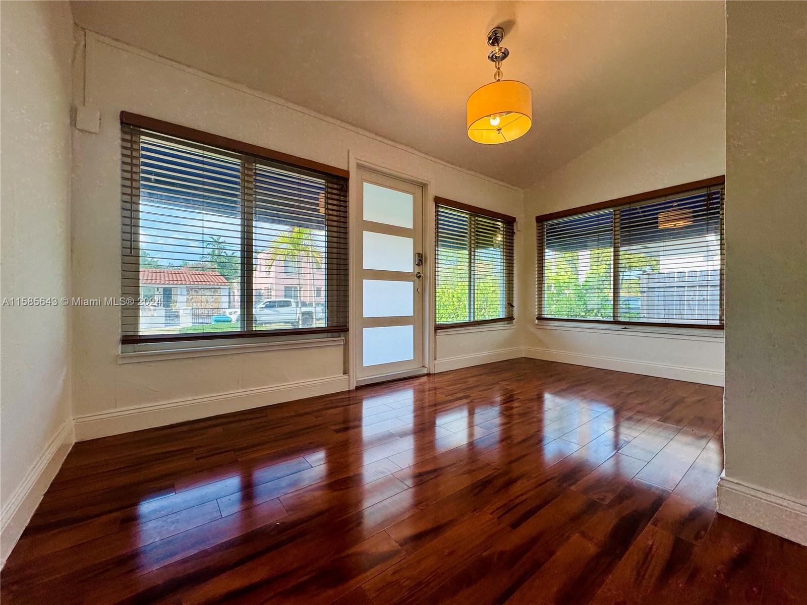 4235 Southwest 14th Street Miami, FL 33134 - Photo 5 of 32 a view of an empty room with wooden floor and a window
