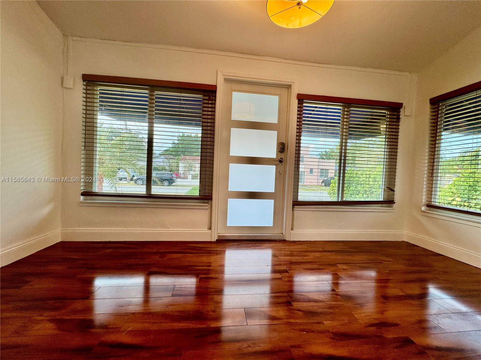 4235 Southwest 14th Street Miami, FL 33134 - Photo 10 of 32 a room with wooden floor and a window