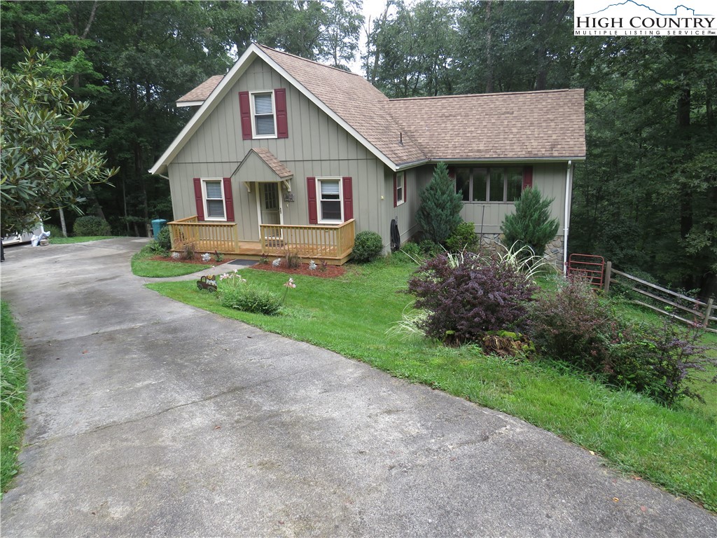 a view of a house with yard and a garden