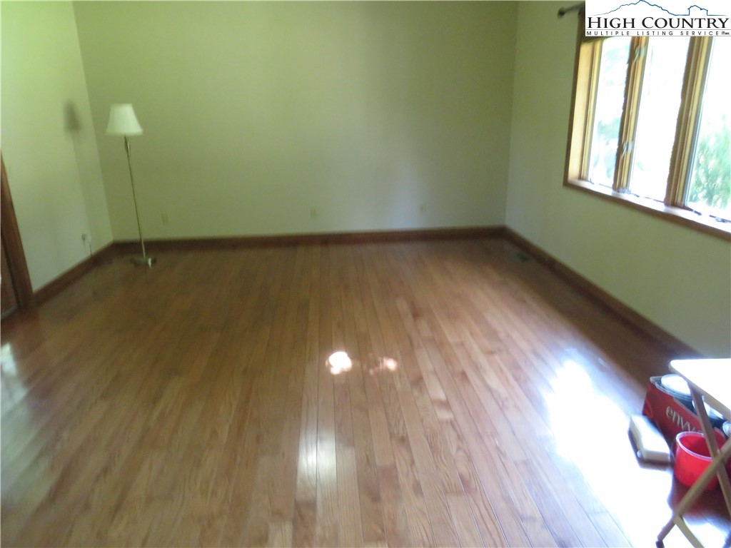 296 Silo Road Sparta, NC 28675 - Photo 11 of 24 a view of a room with wooden floor and windows