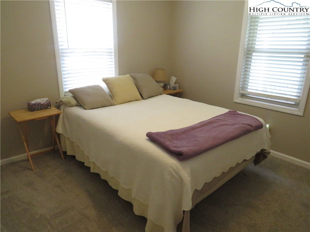 296 Silo Road Sparta, NC 28675 - Photo 14 of 24 a bed sitting in a bedroom next to a window