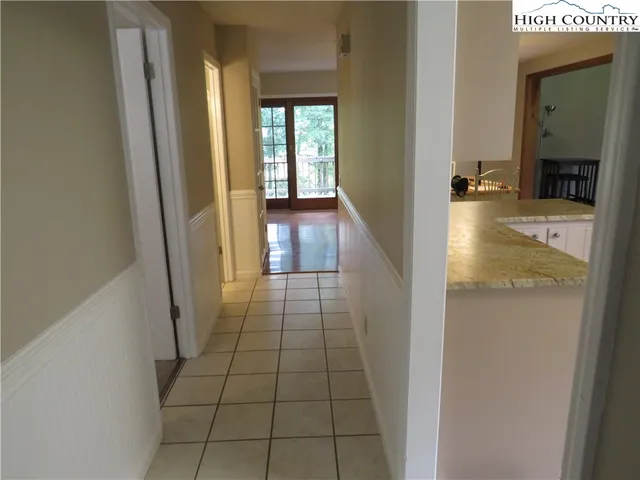 a view of a hallway view with wooden floor and staircase