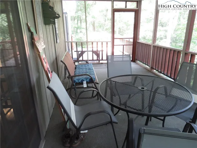 a view of balcony with wooden floor and outdoor seating