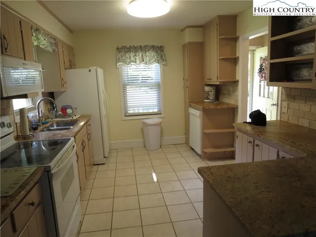 a kitchen with a sink a stove and a refrigerator