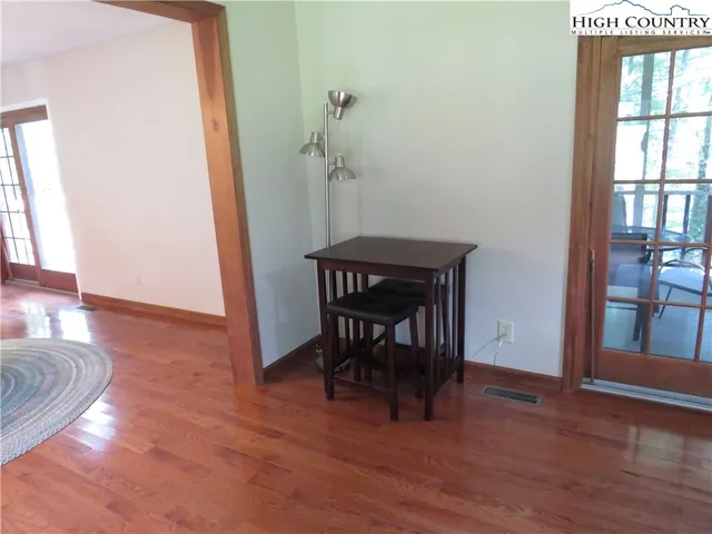 a view of a livingroom with furniture wooden floor and a window