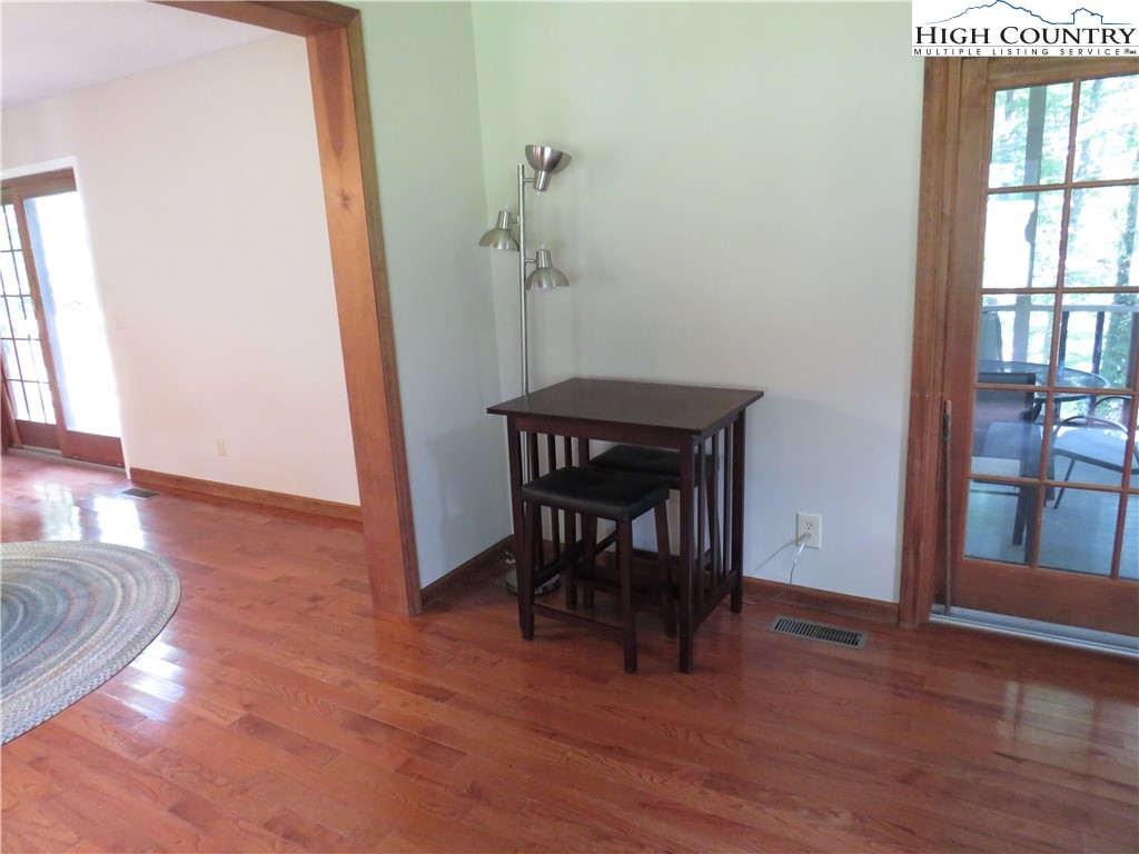 296 Silo Road Sparta, NC 28675 - Photo 7 of 24 a view of a livingroom with furniture wooden floor and a window