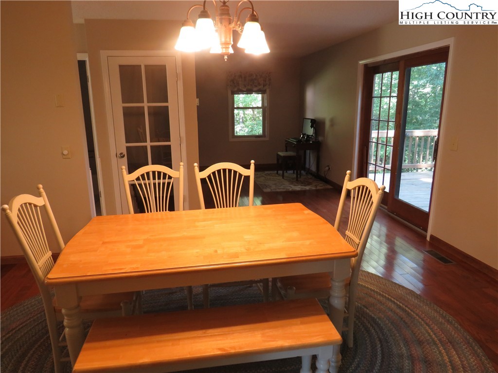 296 Silo Road Sparta, NC 28675 - Photo 10 of 24 a view of a dining room with furniture and wooden floor