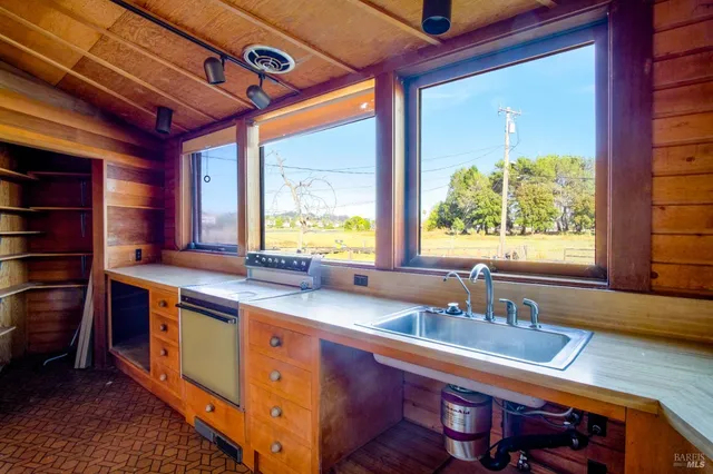 a kitchen with stainless steel appliances granite countertop a sink and a cabinets