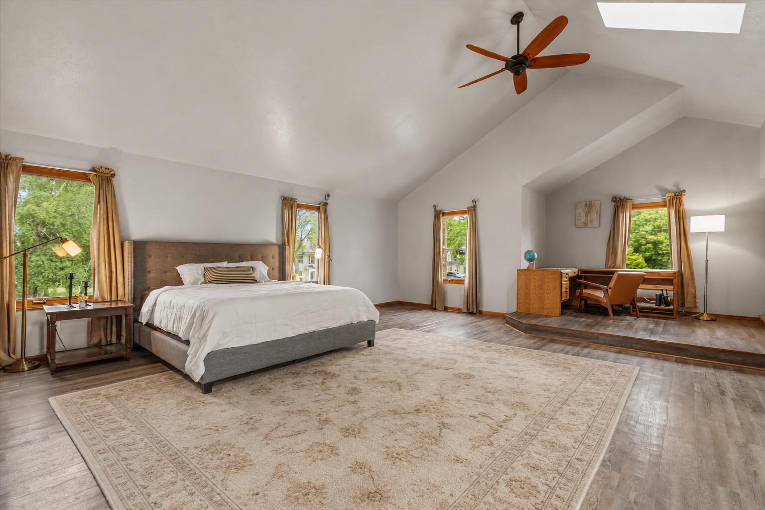 2925 North Main Street Racine, WI 53402 - Photo 8 of 23 Vaulted ceilings, abundant natural light, and a dedicated elevated office or sitting area make this one of the home's most impressive and versatile spaces.