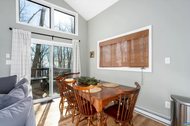 a dining room with furniture a rug and wooden floor