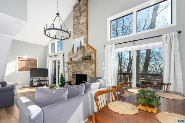 a living room with furniture a fireplace and a large window