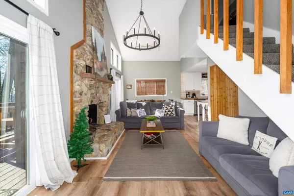 a living room with furniture and a chandelier