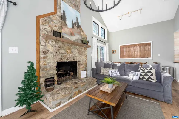 a living room with furniture and kitchen view