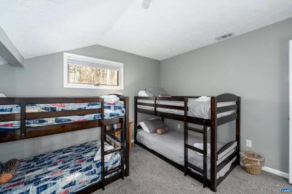 a bedroom with a bed and a dresser in it