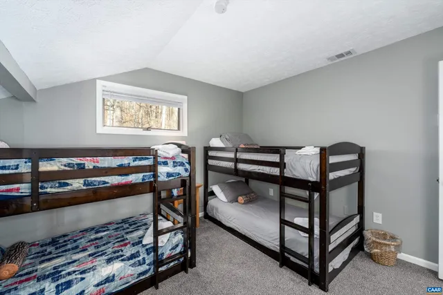 a bedroom with a bed and a dresser in it