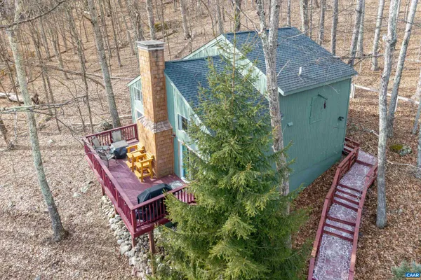 an aerial view of a house with a yard