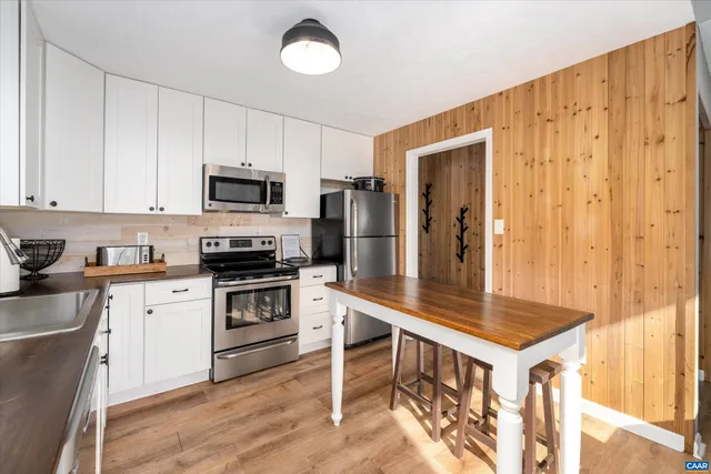 a kitchen with a stove a sink and a refrigerator