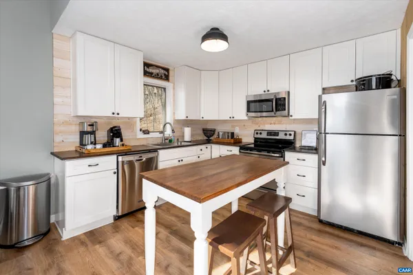 a kitchen with a refrigerator a stove a sink and a refrigerator